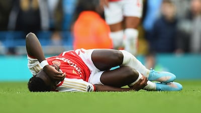 Arsenal's Bukayo Saka took a hit during the match against Manchester City. EPA