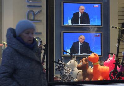 Screens in Saint Petersburg broadcast President Vladimir Putin's annual end-of-year press conference.  Reuters