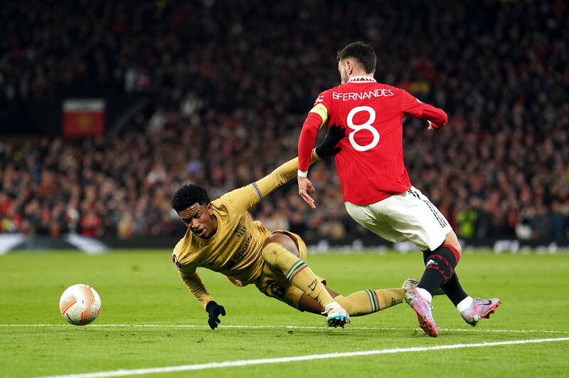 Barcelona's Alex Balde goes down after being pulled by Bruno Fernandes of United to earn the visitors a penalty. PA