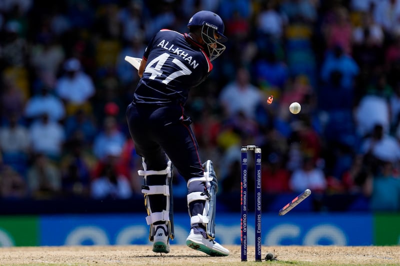 United States batter Ali Khan is bowled out by England's Chris Jordan for a duck.