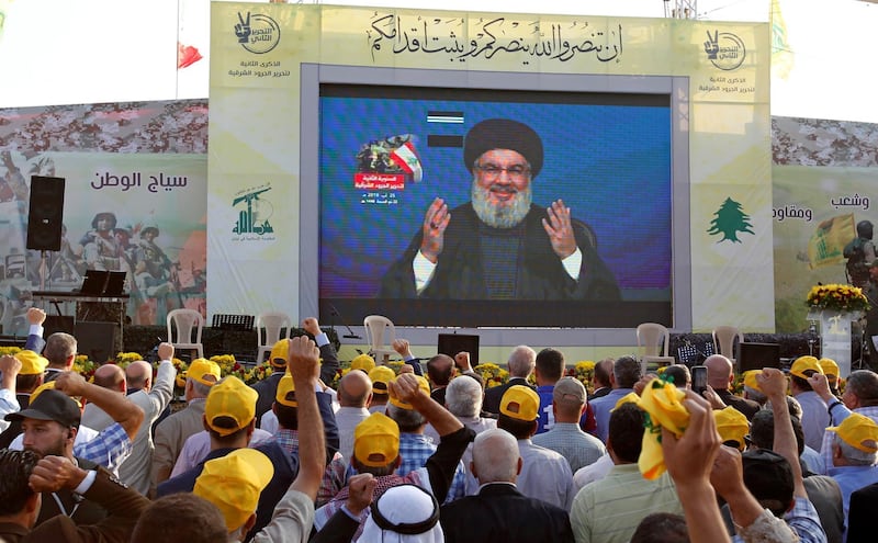 Lebanon's Hezbollah leader Sayyed Hassan Nasrallah gestures as he addresses his supporters via a screen during a rally marking the anniversary of the defeat of militants near the Lebanese-Syrian border, in al-Ain village, Lebanon August 25, 2019. REUTERS/Aziz Taher
