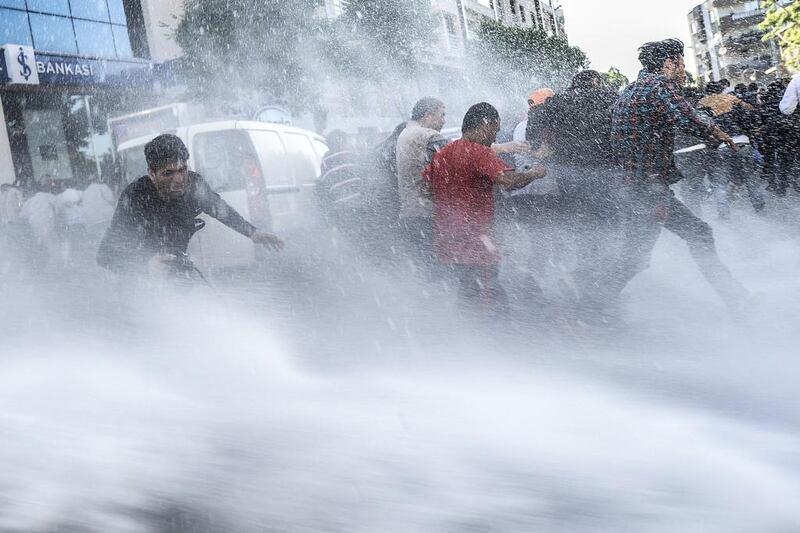 Turkish riot police use water cannons against protestors in Soma. AFP / May 16, 2014