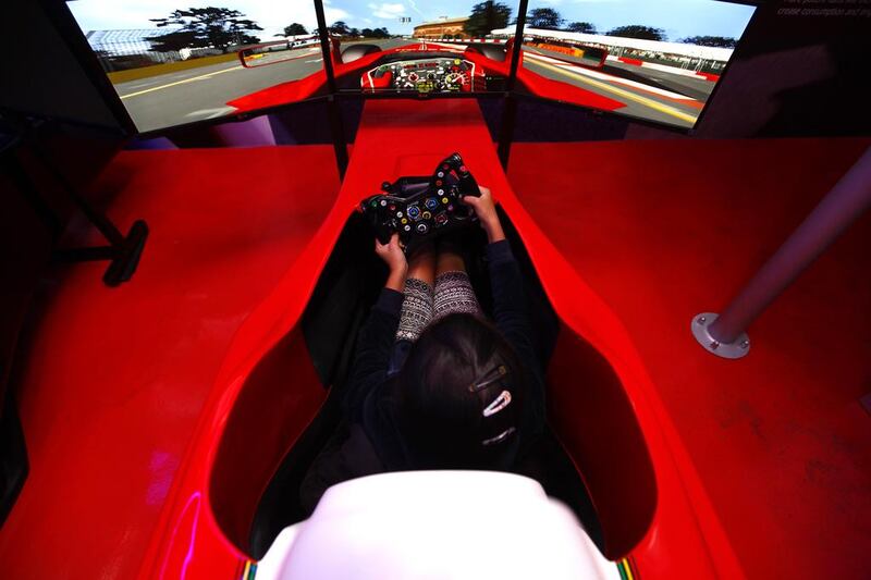 Aishwarya Singh, 10, puts her foot down in a Ferrari F1 simulator at Xxtreme Simulation. Many believe such simulators offer drivers an adrenalin rush they might othewise seek on the streets. Jeffrey E Biteng / The National
