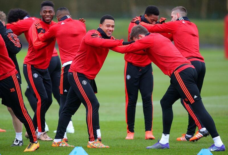 Memphis Depay of Manchester United smiles during a training session ahead of the Uefa Europa League round of 16 first leg match between Liverpool and Manchester United at Aon Training Complex on March 9, 2016 in Manchester, England.  (Photo by Dave Thompson/Getty Images)