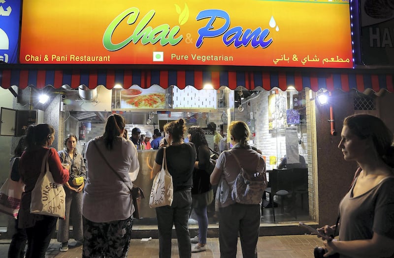 DUBAI , UNITED ARAB EMIRATES , MAY 23 – 2018 :- Participants having snacks and tea at the Chai Pani shop  during the Unseen Trails Iftar Walk presented by Gulf Photo Plus and Frying Pan Adventures in Bur Dubai area in Dubai.  ( Pawan Singh / The National )  For Weekender
