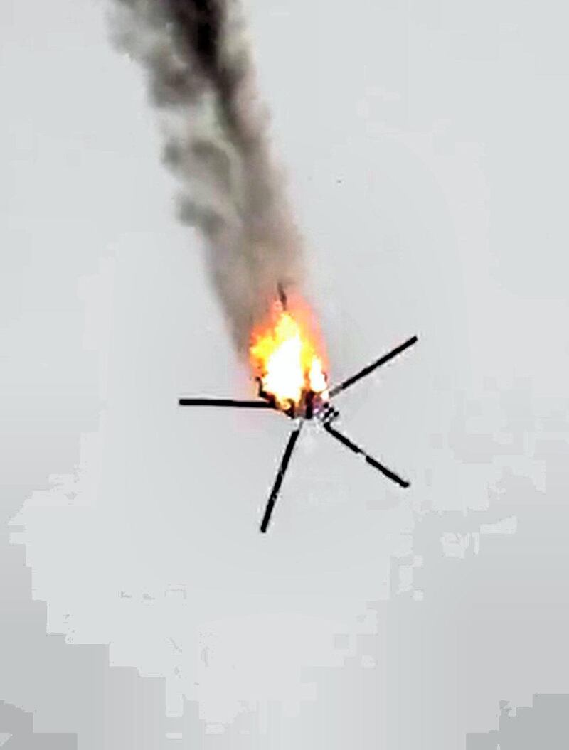 An image grab taken from a video published by jihadists of the Hayat Tahrir al-Sham (HTS) allegedly shows a Syrian military helicopter being downed on February 12, 2020 in Syria's war-torn province of Idlib. - Tensions escalated between Syria's regime and rebel-backer Turkey as a Syrian military helicopter was shot down and Ankara warned of a "heavy price" for any attacks on its forces. The new flare-up, a day after regime shelling killed five Turkish troops, came as government forces battling rebels in northwestern Syria took full control of a key highway linking the country's four largest cities. (Photo by - / Hayat Tahrir al-Sham / AFP) / === RESTRICTED TO EDITORIAL USE - MANDATORY CREDIT "AFP PHOTO / HO / HTS" - NO MARKETING NO ADVERTISING CAMPAIGNS - DISTRIBUTED AS A SERVICE TO CLIENTS FROM ALTERNATIVE SOURCES, AFP IS NOT RESPONSIBLE FOR ANY DIGITAL ALTERATIONS TO THE PICTURE'S EDITORIAL CONTENT, DATE AND LOCATION WHICH CANNOT BE INDEPENDENTLY VERIFIED === / 