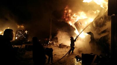 Firefighters at the scene of a missile attack at the port in the coastal city of Latakia, Syria. AP