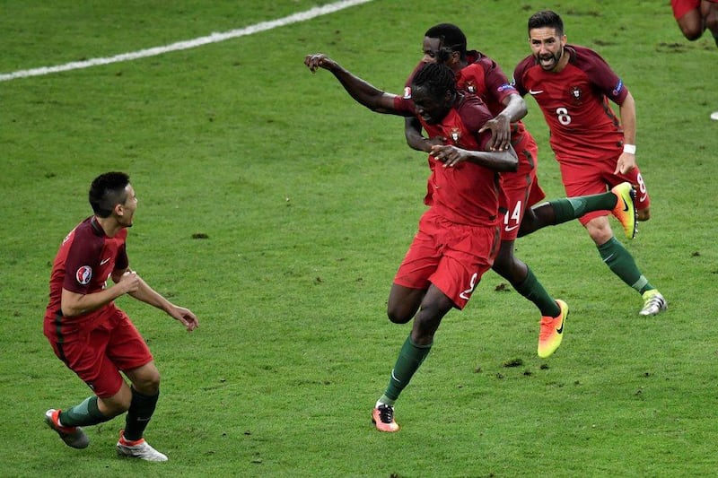 Portugal forward Eder (2L) celebrates after scoring a goal with teammates during the Uefa Euro 2016 Final football match between Portugal and France at the Stade de France in Saint-Denis, north of Paris, on July 10, 2016. Philippe Lopez / AFP