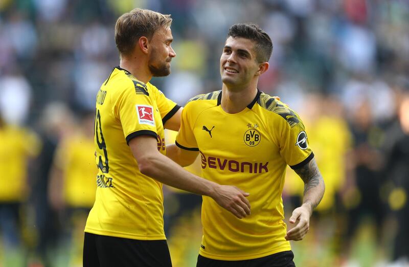 MOENCHENGLADBACH, GERMANY - MAY 18: Christian Pulisic of Dortmund is seen with Marcel Schmelzer of Dortmund after the Bundesliga match between Borussia Moenchengladbach and Borussia Dortmund at Borussia-Park on May 18, 2019 in Moenchengladbach, Germany. (Photo by Lars Baron/Bongarts/Getty Images)