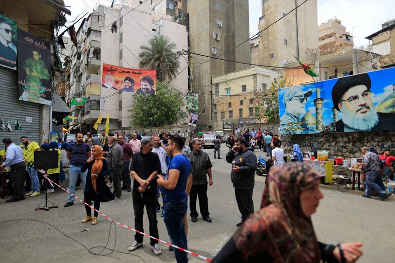 Posters showing Hezbollah leader Hassan Nasrallah hang outside a polling station during Lebanon's parliamentary elections, in Beirut, Lebanon, Sunday, May 6, 2018. Tens of thousands of Lebanese began casting their ballots Sunday in the first parliamentary elections in nine years, with people lining up early in the morning to take part in a vote that is being fiercely contested between rival groups backed by regional powers. (AP Photo/Hassan Ammar)