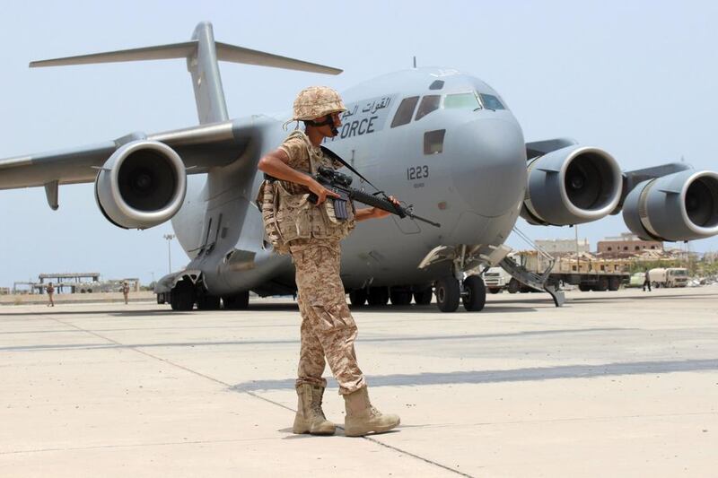 A UAE soldier guards a military plane at Aden airport. Reuters.