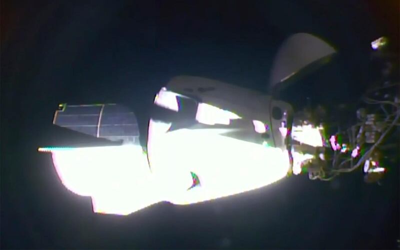 The SpaceX Dragon crew capsule, with Nasa astronauts Doug Hurley and Robert Behnken aboard, docks with the International Space Station. Nasa TV / AP