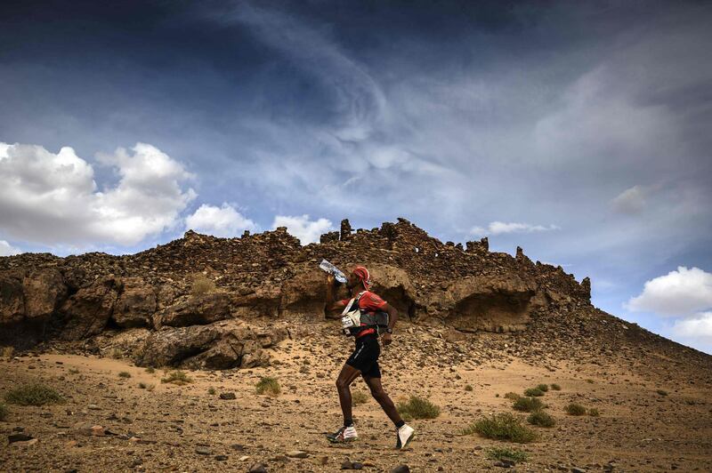 A competitor drinks as he runs during the fourth stage of the Marathon des Sables between Jebel El Mraier and Rich Mbirika in the southern Moroccan Sahara desert. AFP