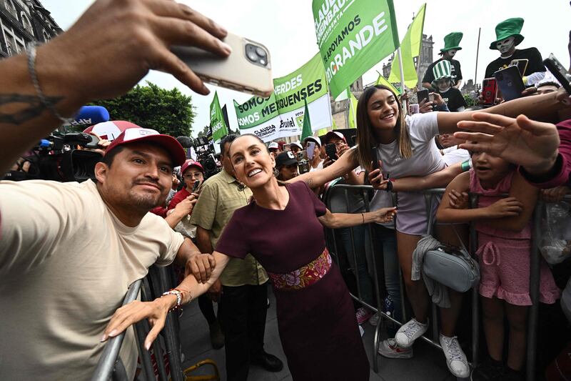 Claudia Sheinbaum, Mexico's presidential candidate for the ruling Morena party, poses with supporters at her closing campaign rally, at Zocalo Square in Mexico City. AFP