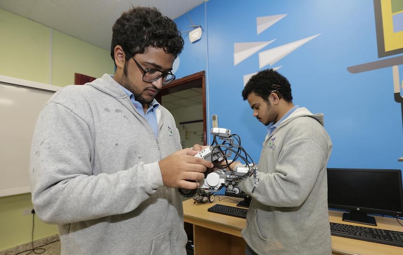 Eighteen year old Mohammed Essam, left, and Khalid Hafez, 20, are learning basic programming at the Al Amal School for Deaf Students in partnership with Microsoft. Jeffrey E Biteng / The National