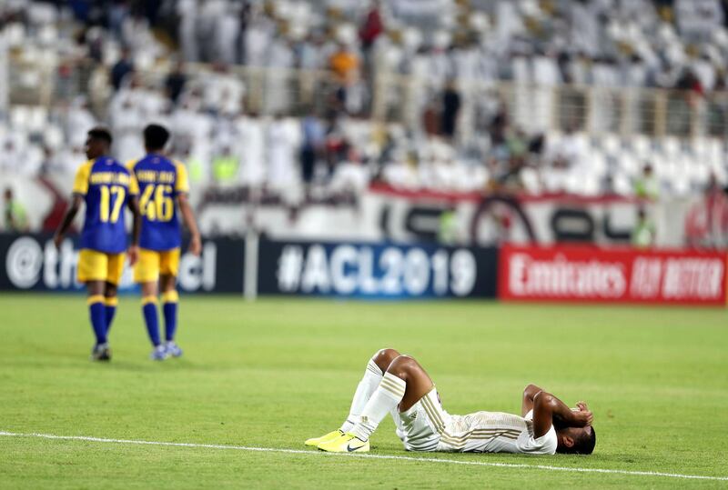 Abu Dhabi, United Arab Emirates - August 12, 2019: Al Wahda's Tahnoon Alzaabi holds his head in his hands after the loss in the Asian Champions League round 16 return leg between Al Wahda of the UAE and Al Nassr of Saudi Arabia. Monday the 12th of August 2019. Al Wadha, Abu Dhabi. Chris Whiteoak / The National