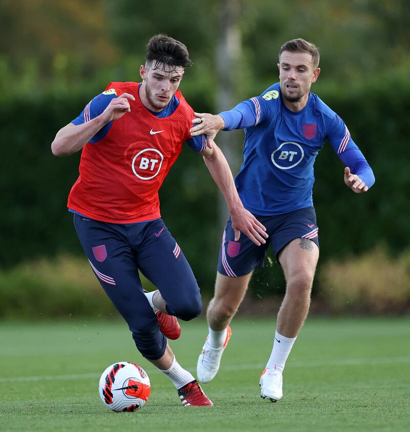 Declan Rice battles for possession with Jordan Henderson during a training session at Tottenham Hotspur Training Centre.