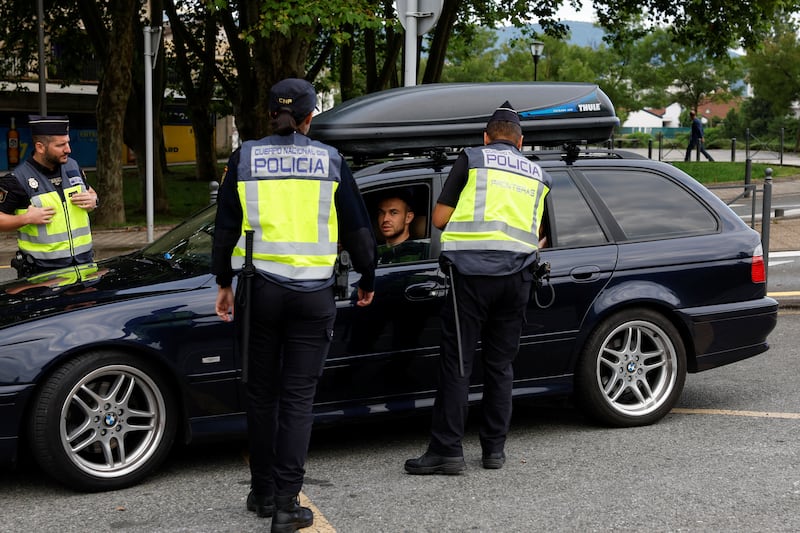 Spanish police officers control traffic on the Spain-France border in Irun. Reuters