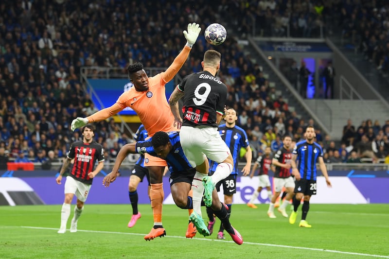 Inter keeper Andre Onana jumps for the ball with Olivier Giroud of AC Milan. Getty Images