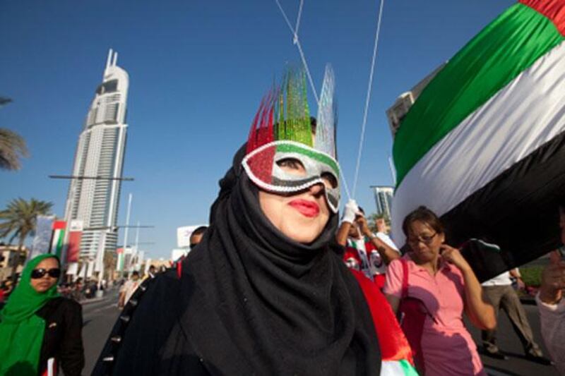 Dubai, United Arab Emirates, Dec 02, 2012 - A woman with a mask from Dubai health care city at the national day parade at Emaar boulevar , downtown Dubai.( Jaime Puebla / The National Newspaper )
