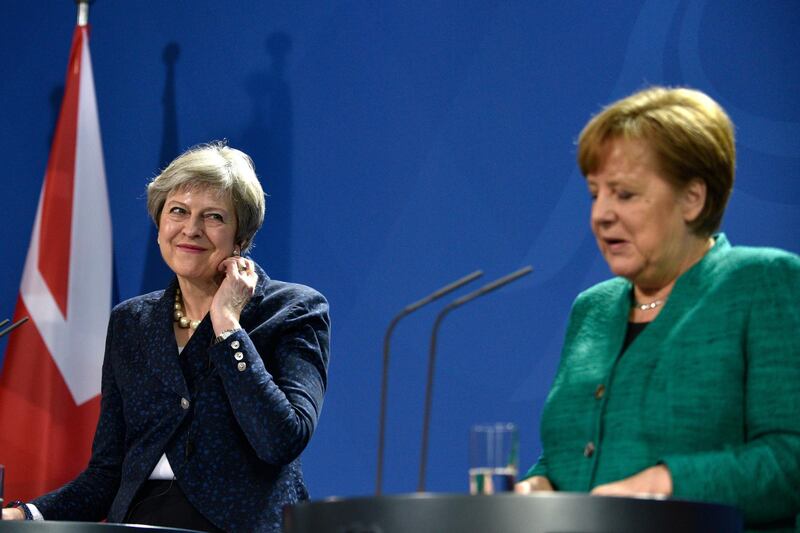 epa06533415 German Chancellor Angela Merkel (R) and British Prime Minister Theresa May (L) address the media during a joint press conference after their meeting at the Chancellery in Berlin, Germany, 16 February 2018. At a joint meeting they discussed about European issues including the euro-exit of Britain and international issues.  EPA/MARKUS HEINE