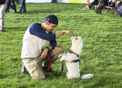 ABU DHABI, UNITED ARAB EMIRATES, 28 OCTOBER 2018 -Pet owner bonding time with their pet at the inaugural of Yas Pet Together event at Yas Du Arena, Abu Dhabi.  Leslie Pableo for The National for Evelyn Lau's story