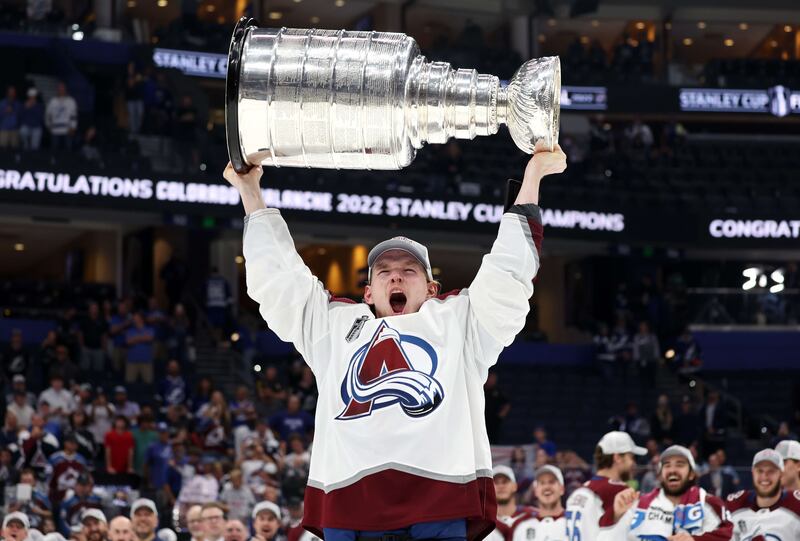 Bowen Byram of the Colorado Avalanche lifts the Stanley Cup after defeating the Tampa Bay Lightning 2-1 in Game Six of the 2022 NHL Stanley Cup Final at Amalie Arena on June 26, 2022 in Tampa, Florida. AFP
