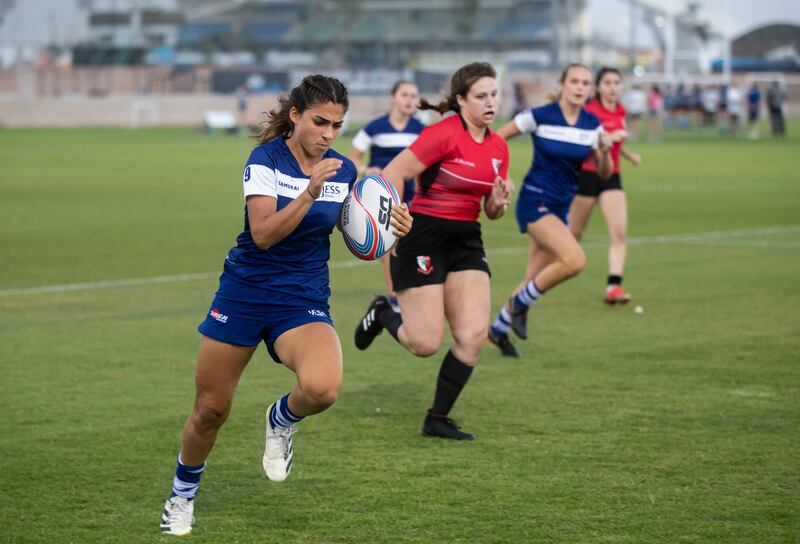 JESS, in blue, in action against Dubai English Speaking College during the British School Al Khubairat Sevens played at the Abu Dhabi Cricket and Sports Hub on Saturday. Ruel Pableo for The National