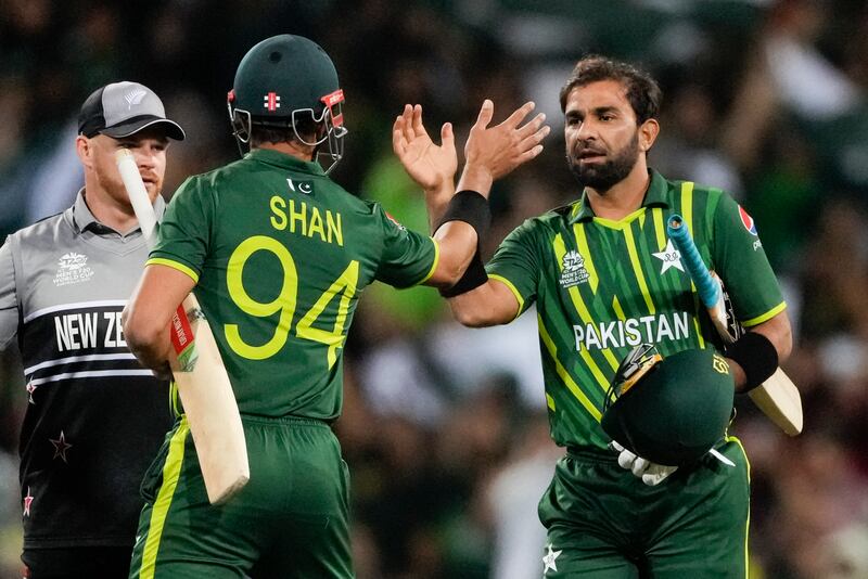 Pakistan's Iftikhar Ahmed, right, and Shan Masood celebrate their seven-wicket win over New Zealand in the T20 World Cup semi-final at Sydney Cricket Ground on November  9, 2022. AP