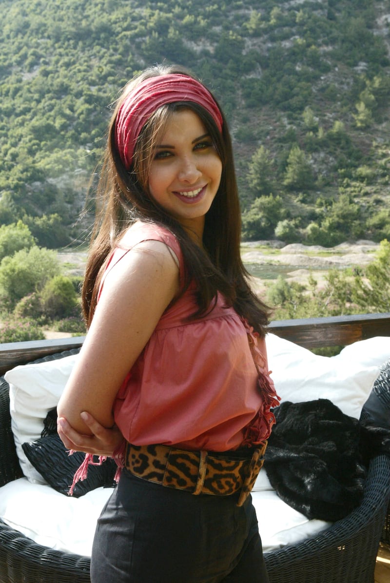 Pretty in a pink top and high-waisted trousers while visiting the Dunniyeh mountains of northern Lebanon on June 26, 2006. AFP