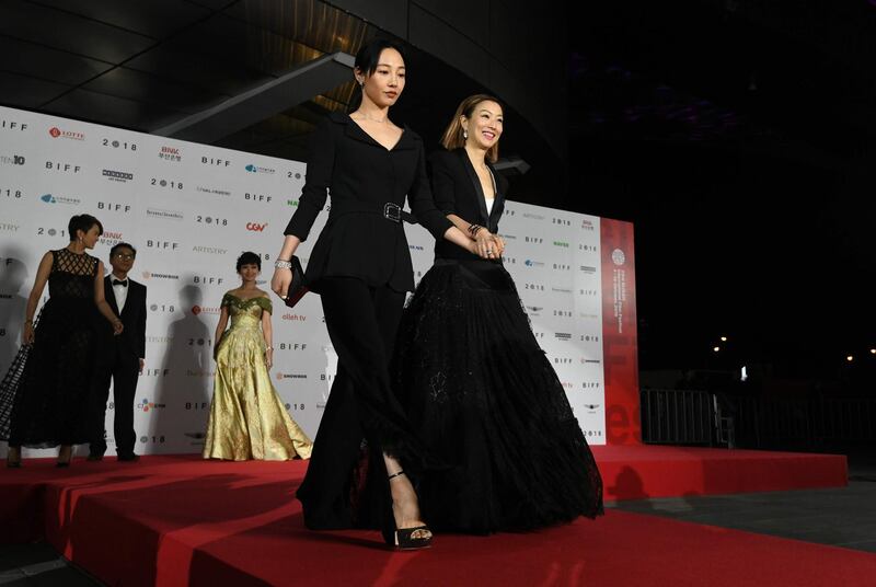 Hong Kong actress Baihe Bai, left, and Sammi Cheng, right, walk down the red carpet during the opening ceremony of the 23rd Busan International Film Festival (BIFF) at Busan Cinema Center in Busan on October 4, 2018. Cheng appears in the drama 'First Night Nerves.' AFP