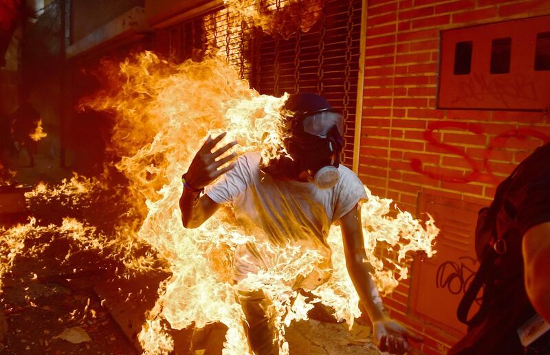 A demonstrator catches fire during clashes with riot police during a protest against Venezuelan President Nicolas Maduro in Caracas. Ronaldo Schemidt / AFP Photo / May 3, 2017