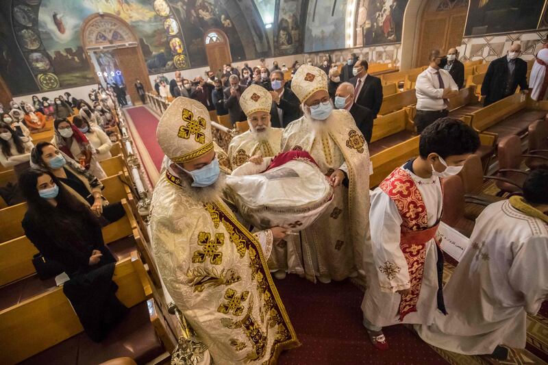Priests lead Christmas Mass at the Archangel Michael Coptic Orthodox Church. The origin of the word “Coptic” is  Aeygyptus – the Greek word for Egypt. AFP