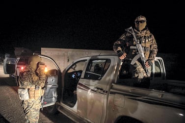 Kurdish YPG fighters stand guard outside Baghouz, Syria as fighting is ongoing to clear the bastion of the last ISIS fighters, 2 March 2019. Campbell MacDiarmid