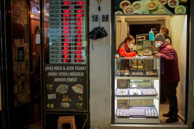 A seller and client in a gold shop next to a currency exchange at the Grand Bazaar in Istanbul, Turkey. AP