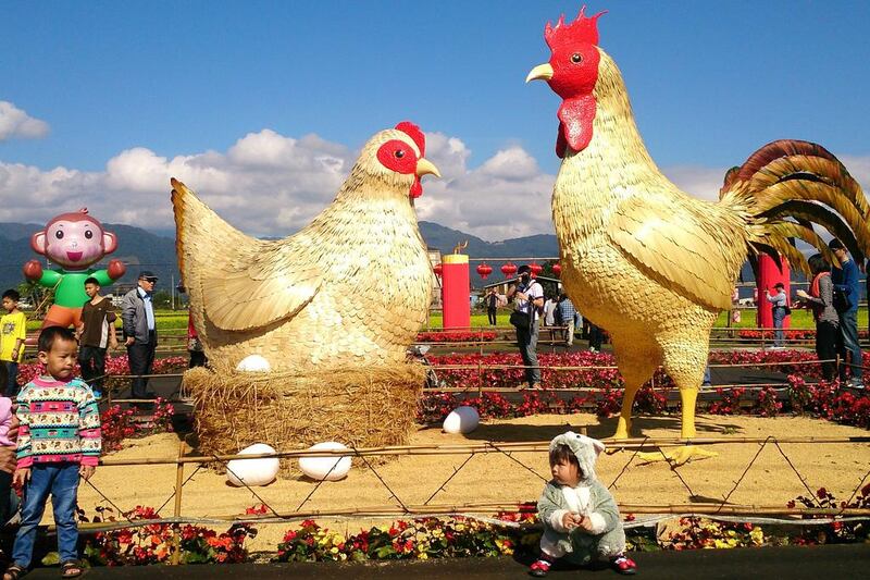 Tourists visit a giant hen and rooster in Sanshing Township in Ilan County in north-east Taiwan on the first day of the Chinese New Year. Sanshing Township Office via EPA