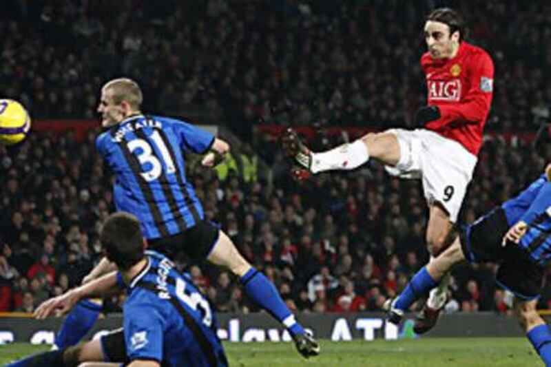 Dimitar Berbatov, right, fires home the winner.