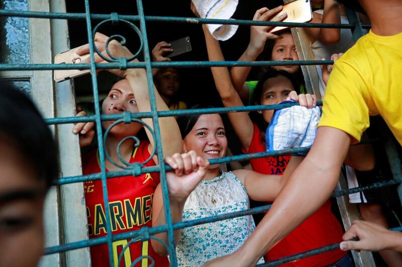 Catholic devotees celebrate as they wait to touch the statue of the Black Nazarene. Reuters