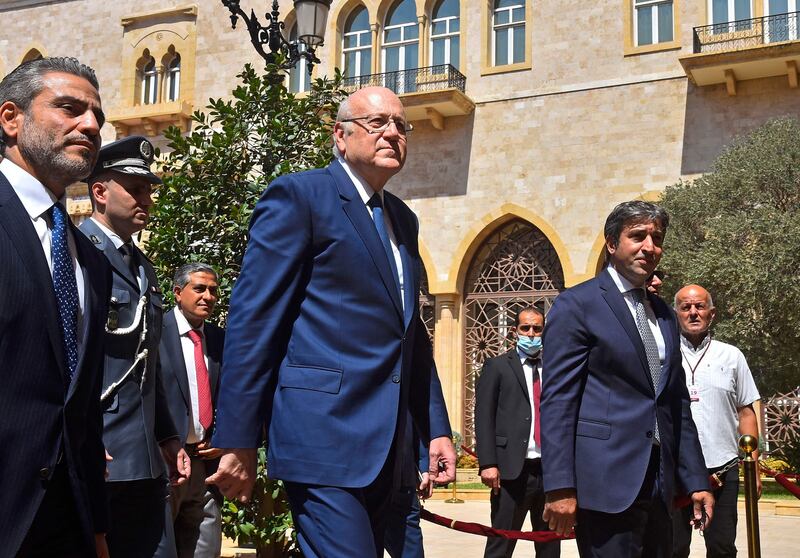 Lebanon's Prime Minister Najib Mikati, centre, has pledged to hold parliamentary elections in 2022. AFP