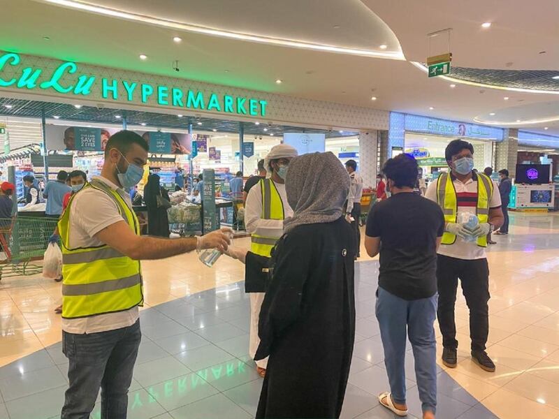Volunteers ask shoppers to sanitise their hands before shopping. Courtesy UAE Volunteers 