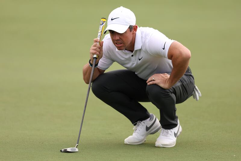 McIlroy lines up a putt on the 11th green. Getty