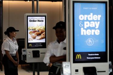 FILE - In this Aug. 8, 2018, file photo employees stand in McDonald's Chicago flagship restaurant. McDonald's Corp. reports financial results Tuesday, April 30, 2019. (AP Photo/Nam Y. Huh, File)