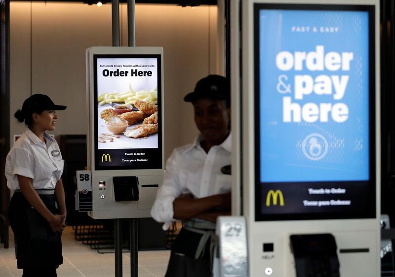 FILE - In this Aug. 8, 2018, file photo employees stand in McDonald's Chicago flagship restaurant. McDonald's Corp. reports financial results Tuesday, April 30, 2019. (AP Photo/Nam Y. Huh, File)