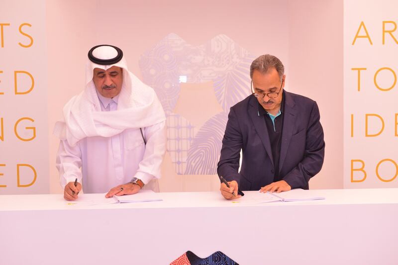 Neom chief executive Nadhmi Al-Nasr (left) signs contracts for the city's new construction village with Al-Tamimi Group and SATCO. Courtesy Neom