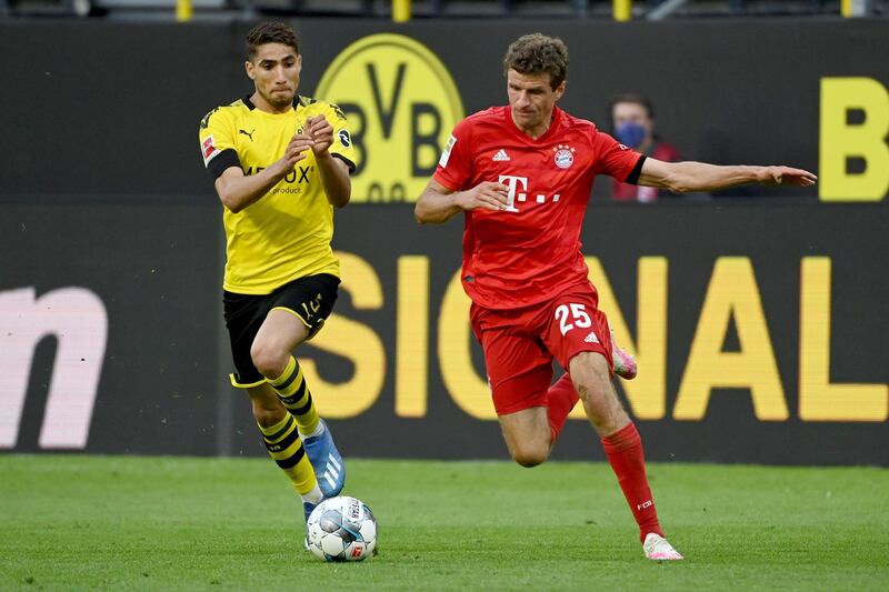 Bayern Munich's German forward Thomas Muller, right, and Dortmund's Moroccan defender Achraf Hakimi vie for the ball. AFP