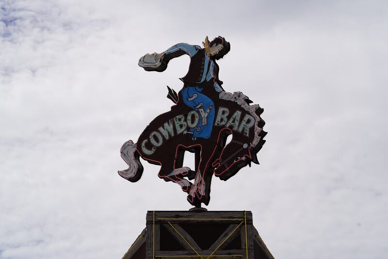 A neon cowboy sign on the roof of a popular bar in Jackson, Wyoming. Willy Lowry / The National