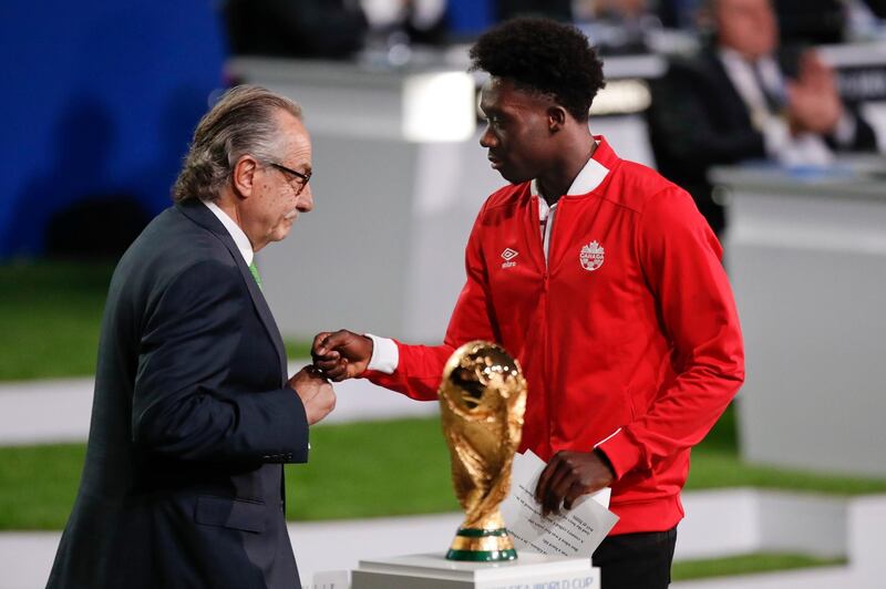 Decio de Maria, President of the Football Association of Mexico, left, and Canadian footballer Alphonso Davies present a joint United bid by Canada, Mexico and the United States to host the 2026 World Cup at the FIFA congress in Moscow, Russia, on June 13, 2018. Pavel Golovkin / AP Photo