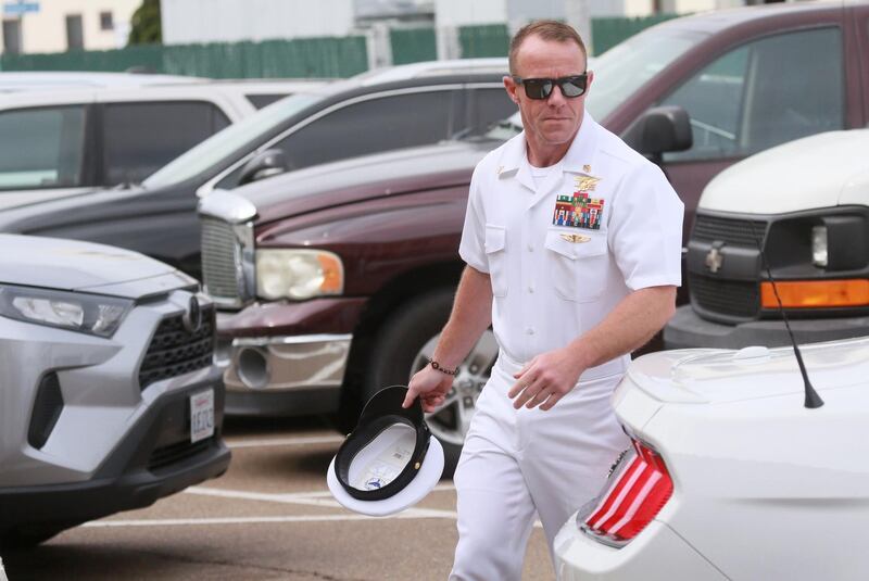 (FILES) In this file photo taken on June 21, 2019 Navy Special Operations Chief Edward Gallagher walks into military court in San Diego, California. A Navy SEAL platoon leader controversially pardoned of war crimes by US President Donald Trump was described as "toxic" and "freaking evil" by veterans who served with him in Iraq, The New York Times reported on December 27, 2019. / AFP / SANDY HUFFAKER
