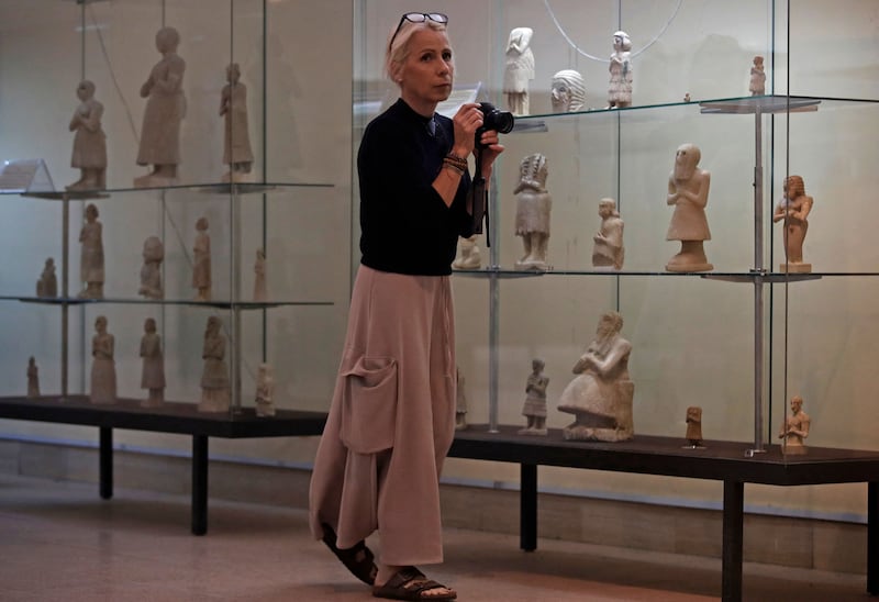 Emma Witters, 54, a YouTube video maker from Hawick in Scotland, visits the National Museum of Baghdad. Tourism authorities in Iraq said 107,000 foreign travellers came to Iraq in 2021, more than three times the number in 2020.