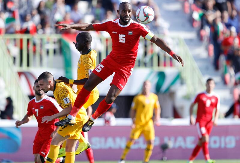 Palestine's defender Abdallatif aL Bahdari jumps for the ball. AP Photo